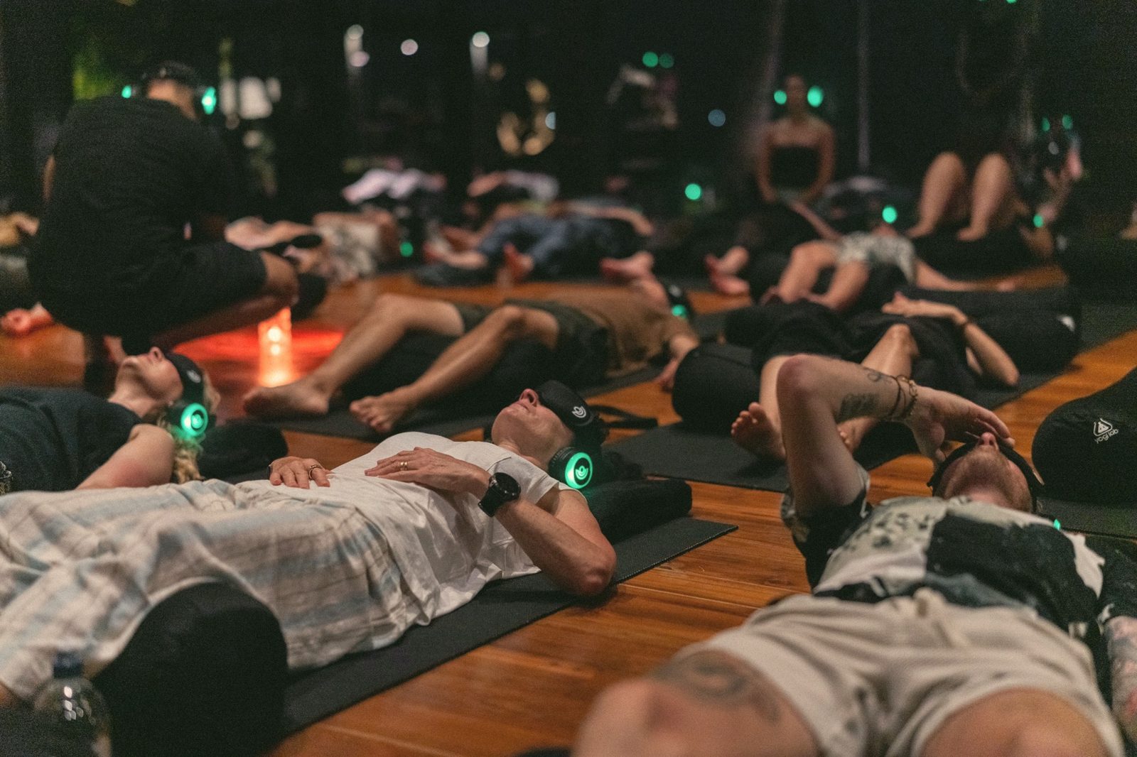 A room of people resting during a breathwork session